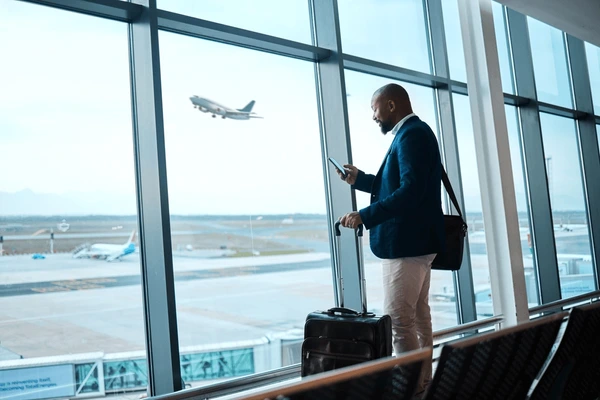 black-man-phone-airport-window-600nw-2262642335